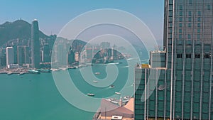 HONG KONG - MAY 2018: Aerial view of Victoria bay from Kowloon district side in 4k. Skyscrapers on the waterfront.