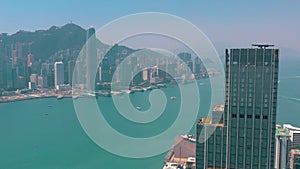 HONG KONG - MAY 2018: Aerial view of Victoria bay from Kowloon district side in 4k. Skyscrapers on the waterfront.