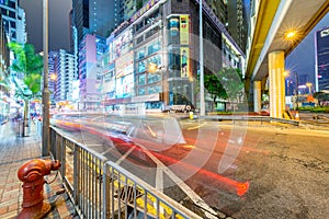 HONG KONG - MAY 4, 2014: City streets and traffic at night. Hong Kong hosts 15 million tourists annually