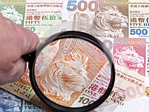 Hong Kong money in a magnifying glass