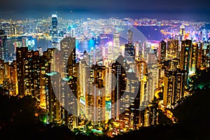 Hong Kong skyscrapers skyline cityscape view from Victoria Peak illuminated in the evening. The most famous view of Hong Kong at