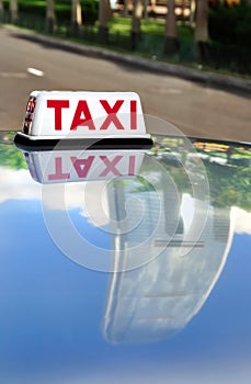 Hong Kong taxi and IFC reflection