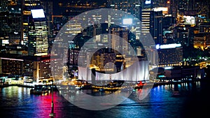 Hong Kong Victoria harbour and its iconic red ancient junk sail zoom shot from the Peak at night