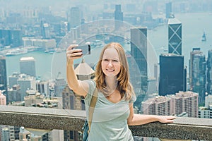 Hong Kong Victoria Peak woman taking selfie stick picture photo