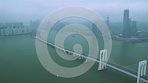 Hong Kong Zhuhai Macao bridge with cars against foggy city