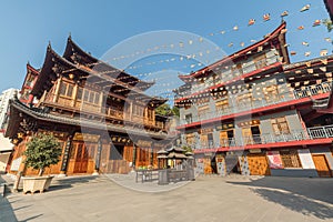 Hongshan Temple with traditional Chinese buddhistic buildings and incense burner against blue sky in Xiamen, China