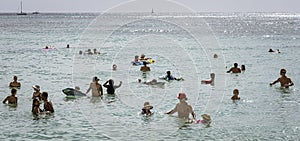 Honolulu, Hawaii - Nov 6, 2021-Young boys play on their boogey boards in the surf