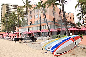 Honolulu, Hawaii -4/27/2018 - Surfboards stacked in front of a hotel on Waikiki Beach, Honolulu, Hawaii