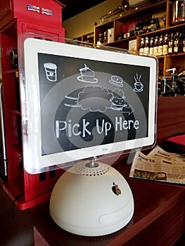 Pick Up Here Sign on Apple Computer at Coffee Shop
