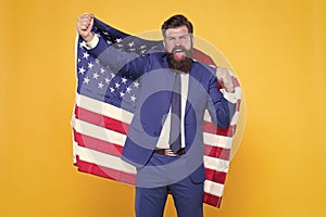 Honour and glory to my country. Happy businessman holding old glory american flag on yellow background. Bearded man in