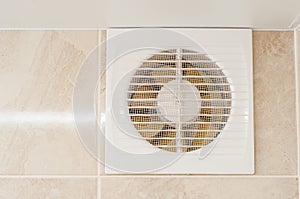 Hood in the bathroom to eliminate dampness and odor. The wall is tiled, yellow engine blades