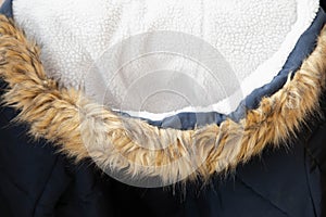 Hood with faux fur on a blue winter jacket close-up