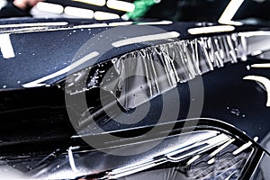 Hood of a modern car during the application of a tranparent protective film