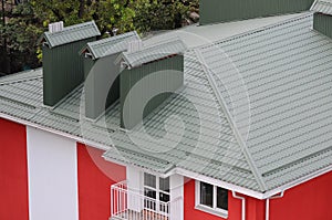 Hood on the roof of the metal sheets. Roofing materials.
