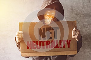 Hooded activist protestor holding Net neutrality protest sign