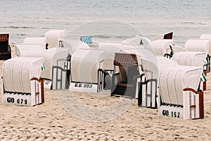 Hooded beach chairs in Baltic sea beach a cloudy day of Summer., Sellin, Germany