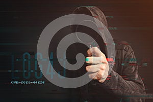Hooded computer hacker in cybersecurity vulnerability Log4J concept