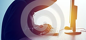 Hooded computer hacker hacking network
