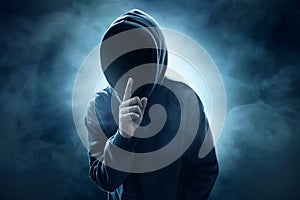 Hooded computer hacker on smoke background