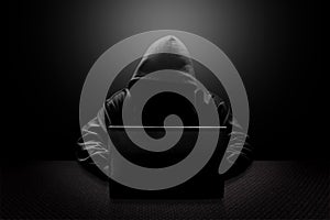 Hooded computer hacker stealing information