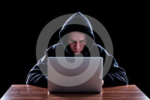 Hooded computer hacker stealing information