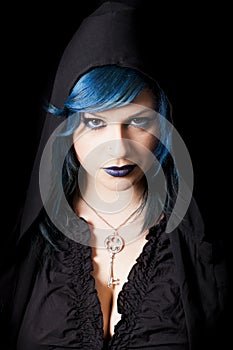 Hooded dark woman with blue hair and lipstick. Key pendant