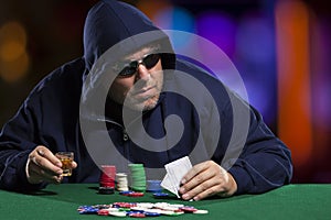 Hooded Male Poker Player with Cards