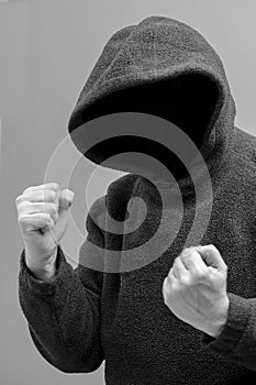Hooded man intent on violence photo