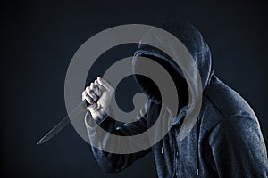 Hooded man with knife