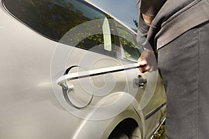 Hooded man trying to steal car fuel on public park place