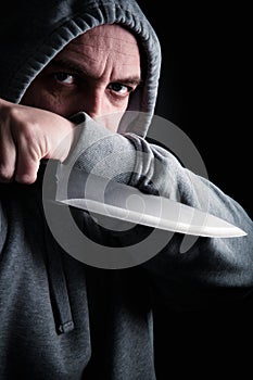 Hooded robber wielding a knife