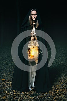 Hooded woman with lantern