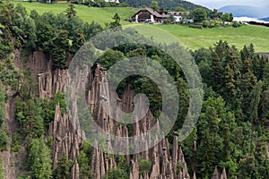 Hoodoos in front of a farm in South Tyrol, Northern Italy