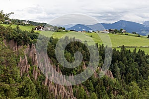 Hoodoos in front of a scenic landscape of South Tyrol, Northern Italy