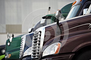 Hoods three semi trucks standing on truck stop