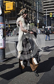 Hoofed bagpipe player in downtown Vancouver - front