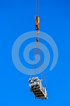 The hook of the crane lifts freight.