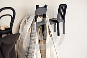 The hook is designed on a white wall.