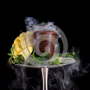 Hookah bowl with tobacco on an black background