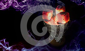 Hookah hot coals for smoking shisha and leisure in east pattern background.