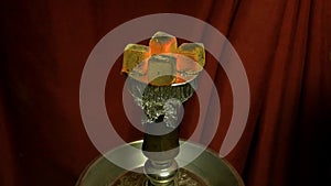 Hookah hot coals for smoking shisha and leisure in east pattern background. Bowl with tobacco and coal. Hookah hot coals