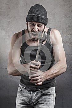 Hooligan shouting a threatening with a wrench photo