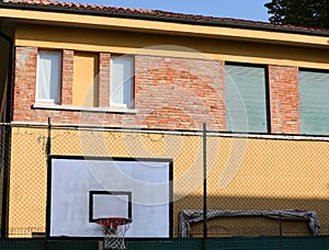 hoop in a prison reformatory basketball court with no people