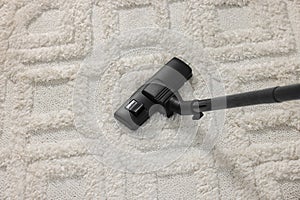 Hoovering carpet with vacuum cleaner, above view