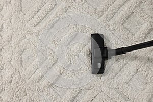 Hoovering carpet with vacuum cleaner, top view. Space for text