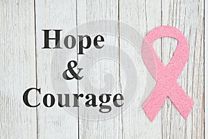 Hope and Courage message with pink ribbon on textured weathered whitewash wood