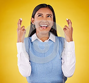 Hope, fingers crossed and young woman in a studio wishing for success, winning or achievement. Happiness, smile and