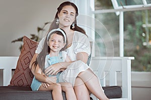 Hope is frail, teach her strength. an adorable little girl relaxing with her mother on the sofa at home.