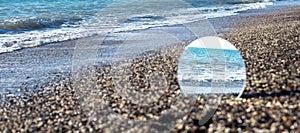 Hope, freedom and escape concept. Sea in the reflection of the round mirror.