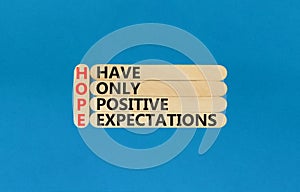 HOPE have only positive expectations symbol. Concept words HOPE have only positive expectations on stick on beautiful blue